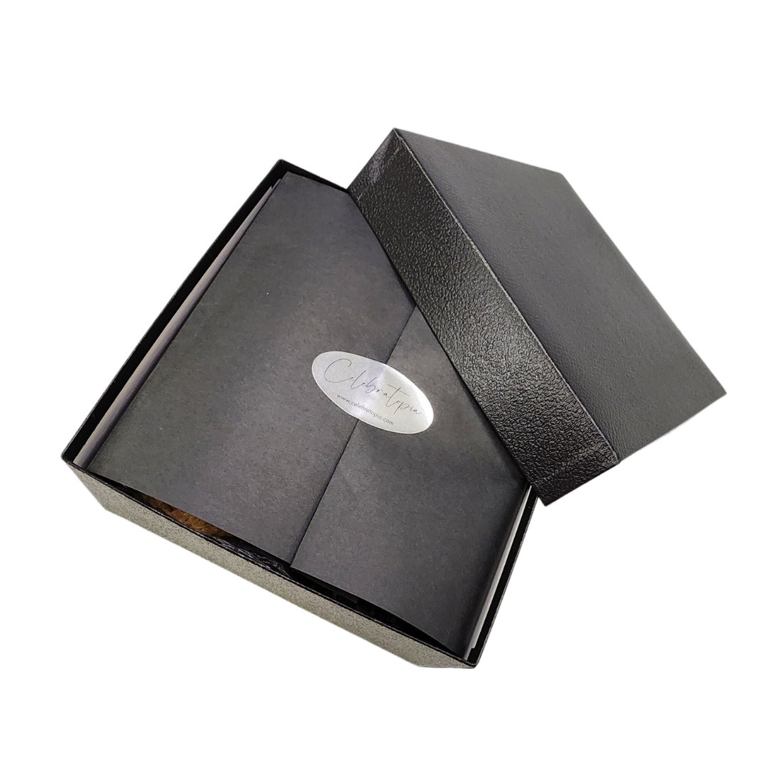 black gift box with black paper wrap and silver seal