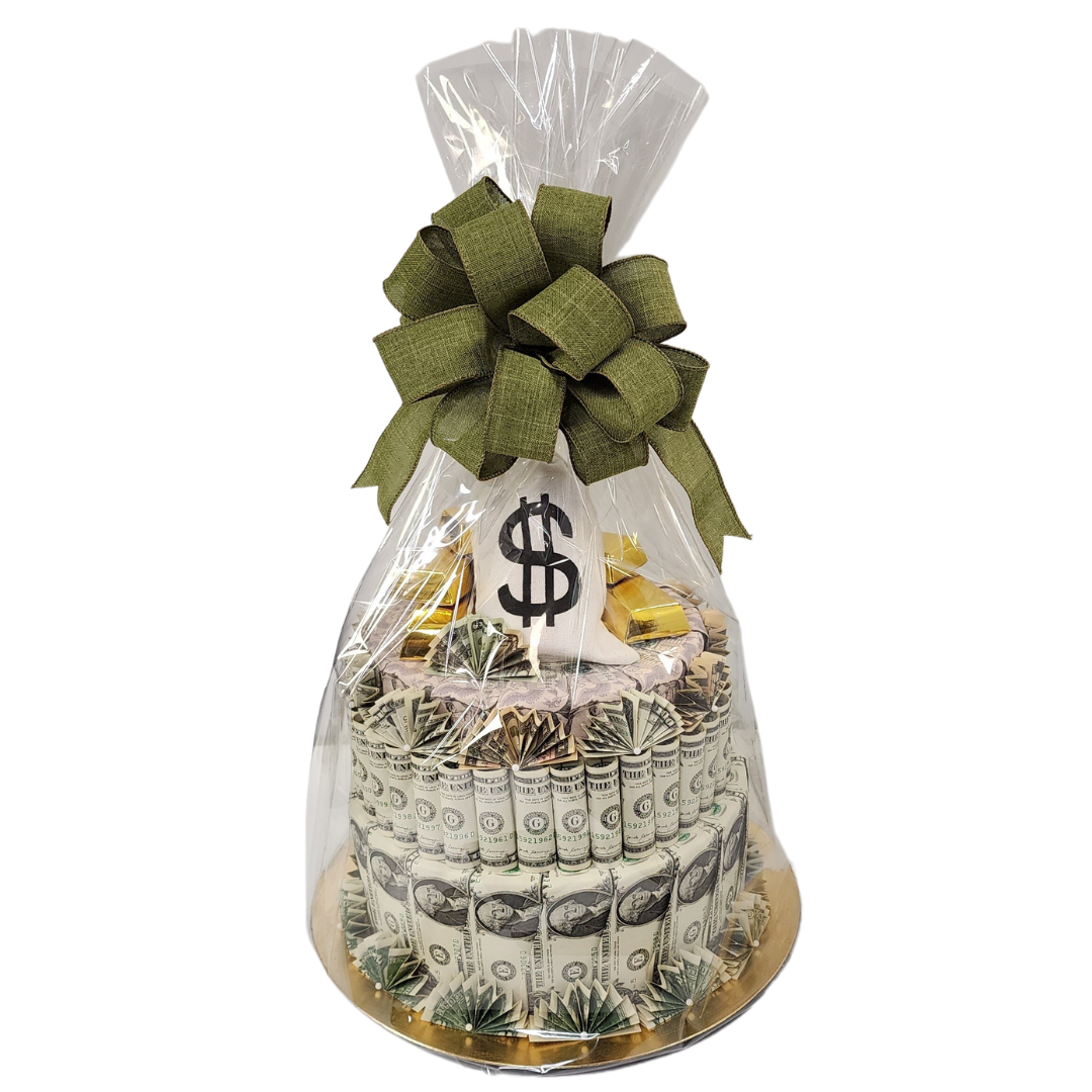 faux cake made out of US currency wrapped in cellophane and a green bow