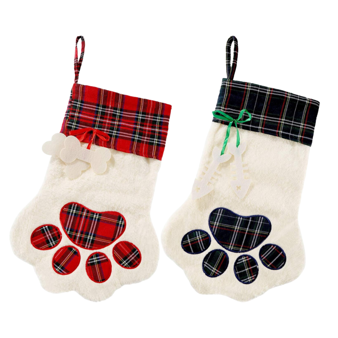 red plaid cuff paw print christmas stocking with a felt dog bone embellishment and a green plaid paw print sotcking with a fish bone embellishment