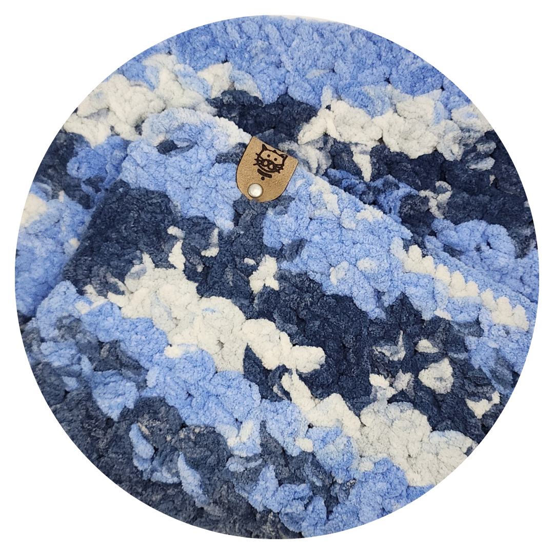 crocheted cat mat in blue and white tones