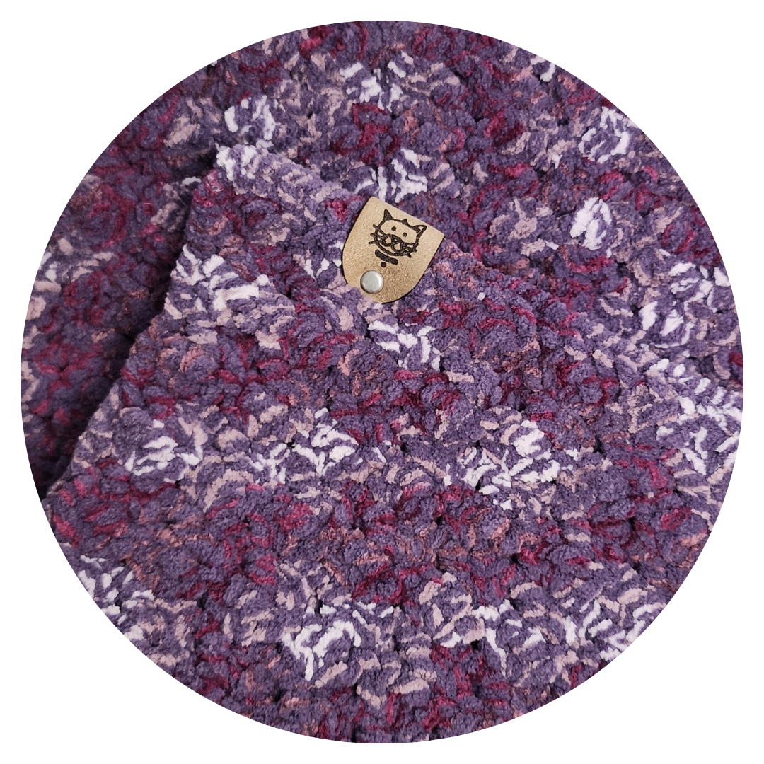 crocheted cat pad in purple plum and white tones
