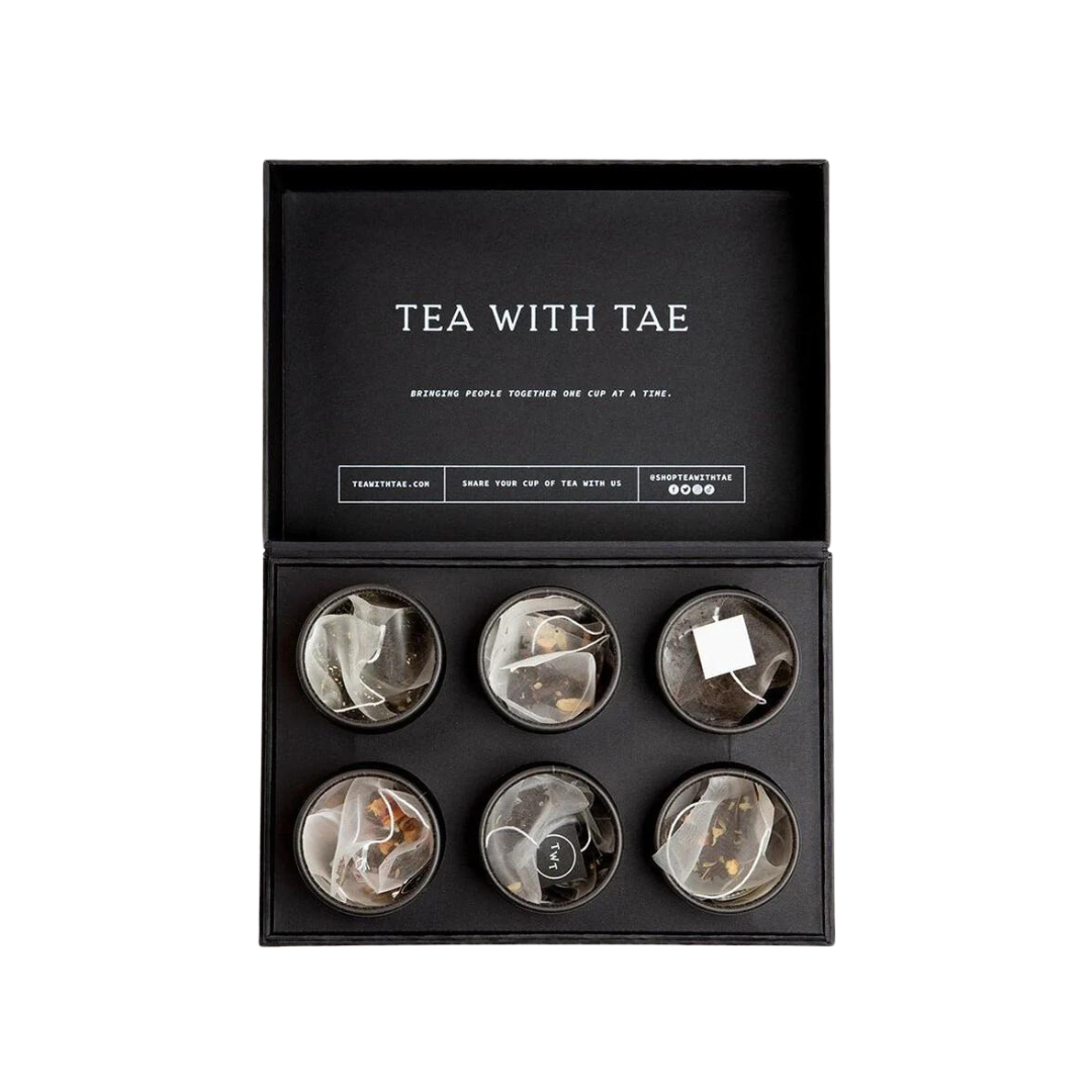 black gift box with open tubes showing pyramid tea satchets