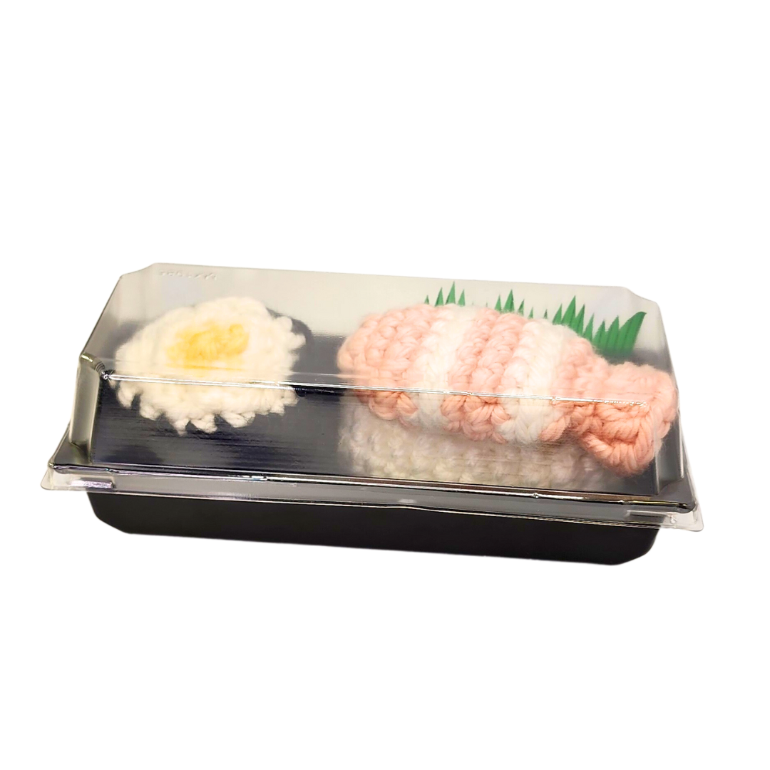 SUSHI CATNIP TOYS, SET OF 2 in a plastic container showcasing crocheted sushi designs, filled with organic catnip, perfect for playful cats.