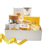 DO WHAT MAKES YOU HAPPY GIFT SET featuring a journal, Meyer Lemon Shortbread Cookies, White Lemon Ginger Tea, and more, all elegantly packed for a thoughtful gift.