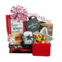 GATHER HERE GIFT SET: A welcoming gift basket featuring a blue star candle holder, red photo frame, patriotic decor, and snack mixes, perfect for new homes.