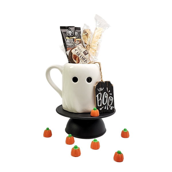 HEY BOO HALLOWEEN LATTE GIFT featuring a white ghost mug with candies, biscotti, and coffee packets, wrapped with a festive Halloween tag and bow.