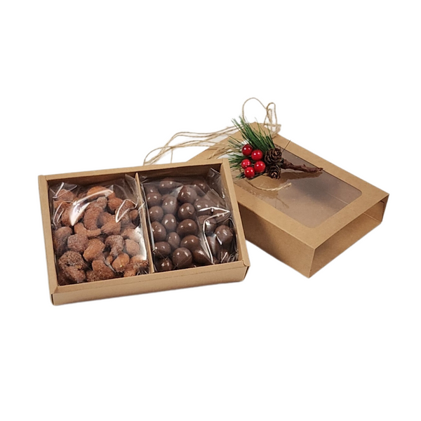 GOURMET TREATS IN A HOLIDAY GIFT BOX featuring chocolate pretzel balls and honey roasted cashews in a festive kraft slider box with holiday embellishments.