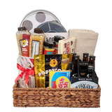 Movie Night Popcorn Gift Set in a wicker basket, featuring popcorn, candy, beverages, and a cozy blanket for an ultimate home movie experience.