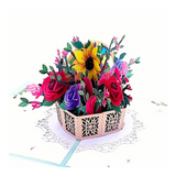 Spring Time Pop Up Card featuring intricate paper flowers in a basket, perfect for gifting. Includes recycled materials and a blank note card.